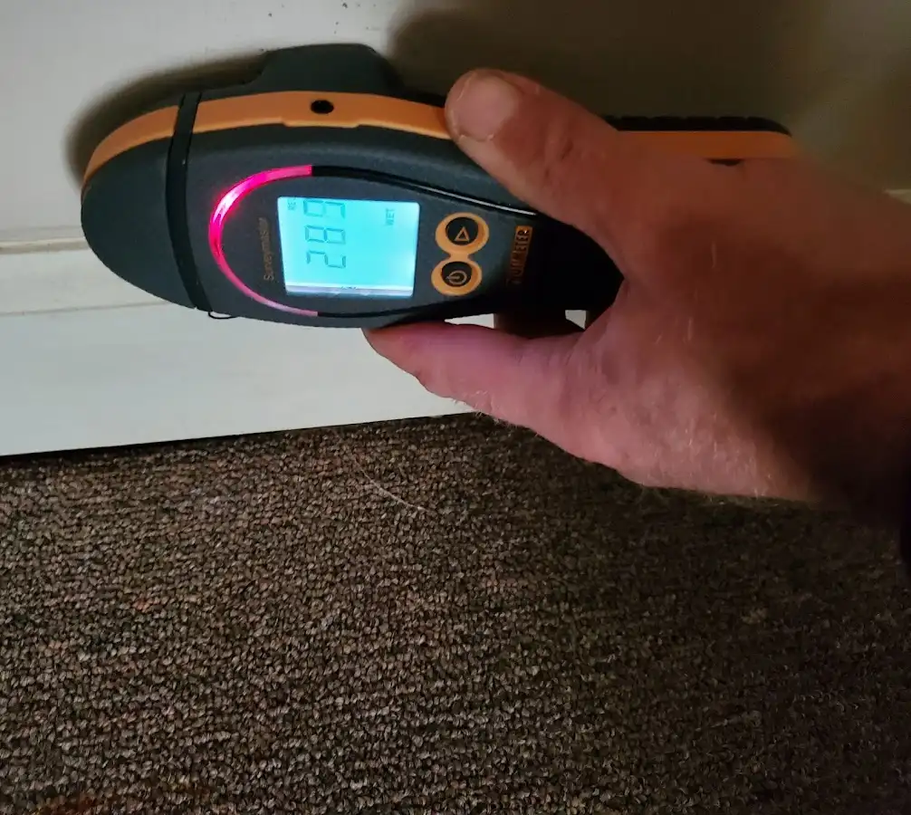 Moisture detection at baseboard during Storm Damage Restoration in Orlando